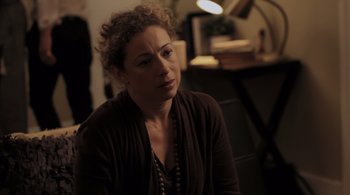 Movie still from “Like Crazy” (2011), directed by Drake Doremus – A woman sitting in front of a desk looking off to her right; Close Up shot, Over the shoulder angle