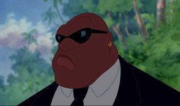 Movie still from “Lilo & Stitch” (2002), directed by Dean DeBlois – A man in a suit and tie wearing sunglasses; Close Up shot, Low angle