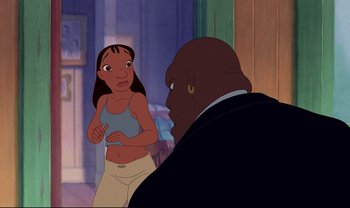 Movie still from “Lilo & Stitch” (2002), directed by Dean DeBlois – An animated scene of a woman talking to a man; Medium shot, Over the shoulder angle