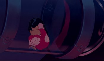 Movie still from “Lilo & Stitch” (2002), directed by Dean DeBlois – A little girl sitting on the ground in front of an object; Wide shot, High angle