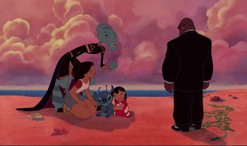 Movie still from “Lilo & Stitch” (2002), directed by Dean DeBlois – A group of people standing around a little girl and lilo; Wide shot, Over the shoulder angle