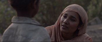 Movie still from “Lion” (2016), directed by Garth Davis – A woman wearing a headscarf talking to another woman; Close Up shot, Over the shoulder angle