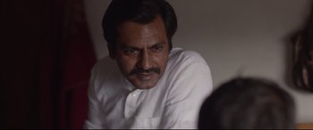 Movie still from “Lion” (2016), directed by Garth Davis – A person wearing a white shirt; Close Up shot, Over the shoulder angle