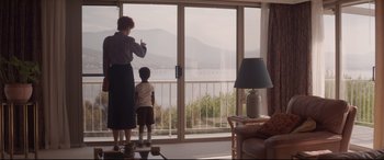 Movie still from “Lion” (2016), directed by Garth Davis – A woman and a child looking out of a window; Wide shot, Over the shoulder angle