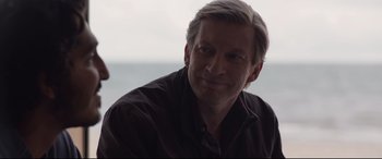 Movie still from “Lion” (2016), directed by Garth Davis – A person wearing a brown shirt; Close Up shot, Over the shoulder angle