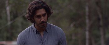 Movie still from “Lion” (2016), directed by Garth Davis – A person with long hair; Close Up shot, Over the shoulder angle