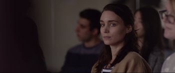 Movie still from “Lion” (2016), directed by Garth Davis – A young woman is looking into the distance while standing next to a young man; Close Up shot, Over the shoulder angle