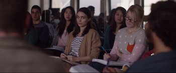 Movie still from “Lion” (2016), directed by Garth Davis – A group of people sitting in a room with papers; Medium shot, Over the shoulder angle