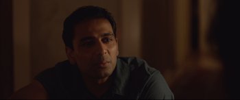 Movie still from “Lion” (2016), directed by Garth Davis – A person sitting in front of a window; Close Up shot, Over the shoulder angle