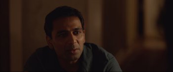 Movie still from “Lion” (2016), directed by Garth Davis – A person sitting in front of a window; Close Up shot, Over the shoulder angle