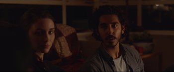 Movie still from “Lion” (2016), directed by Garth Davis – A man and a woman sitting on a couch; Close Up shot, Over the shoulder angle
