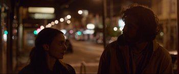 Movie still from “Lion” (2016), directed by Garth Davis – A man and a woman standing next to each other on a street; Close Up shot, Over the shoulder angle