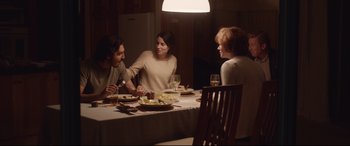 Movie still from “Lion” (2016), directed by Garth Davis – A group of people sitting at a dinner table; Medium shot, Over the shoulder angle