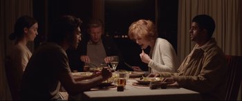 Movie still from “Lion” (2016), directed by Garth Davis – A group of people sitting at a dinner table; Medium shot, High angle