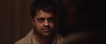 Movie still from “Lion” (2016), directed by Garth Davis – A person wearing a jacket; Close Up shot, Over the shoulder angle