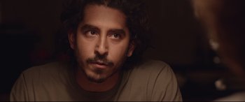 Movie still from “Lion” (2016), directed by Garth Davis – A person with long hair; Close Up shot, Over the shoulder angle