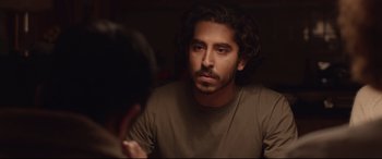 Movie still from “Lion” (2016), directed by Garth Davis – A person looking at a mirror; Close Up shot, Over the shoulder angle
