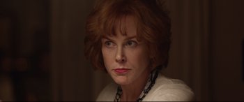 Movie still from “Lion” (2016), directed by Garth Davis – A person wearing a necklace; Close Up shot, Over the shoulder angle
