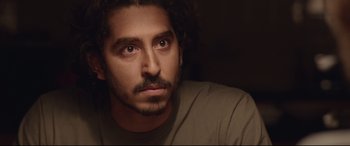 Movie still from “Lion” (2016), directed by Garth Davis – A person with long hair and a beard; Close Up shot, Over the shoulder angle