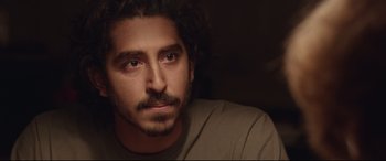 Movie still from “Lion” (2016), directed by Garth Davis – A person with a beard; Close Up shot, Over the shoulder angle