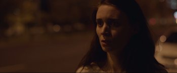 Movie still from “Lion” (2016), directed by Garth Davis – A woman with long red hair is looking at the camera; Close Up shot, Low angle