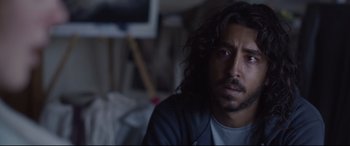 Movie still from “Lion” (2016), directed by Garth Davis – A person sitting in a room; Close Up shot, Low angle