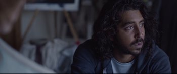 Movie still from “Lion” (2016), directed by Garth Davis – A person with long curly hair; Close Up shot, Over the shoulder angle