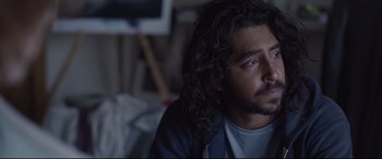 Movie still from “Lion” (2016), directed by Garth Davis – A person with long black hair; Close Up shot, Over the shoulder angle