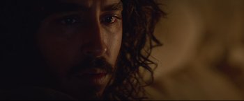 Movie still from “Lion” (2016), directed by Garth Davis – A person with long hair; Close Up shot, Over the shoulder angle