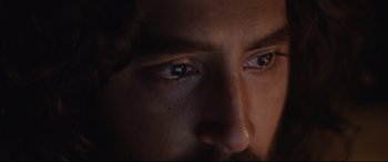 Movie still from “Lion” (2016), directed by Garth Davis – A man's eyes in the dark; Extreme Close Up shot, Low angle