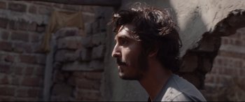 Movie still from “Lion” (2016), directed by Garth Davis – A person with a beard; Close Up shot, Over the shoulder angle