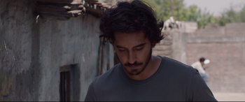 Movie still from “Lion” (2016), directed by Garth Davis – A person wearing a gray shirt; Close Up shot, Low angle