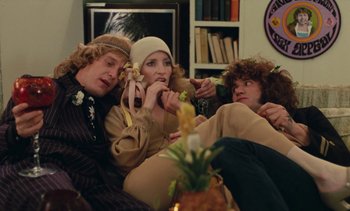 Movie still from “Lions Love (... and Lies)” (1969), directed by Agnès Varda – A group of people sitting on top of a couch; Medium shot, High angle