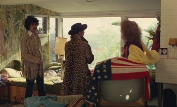 Movie still from “Lions Love (... and Lies)” (1969), directed by Agnès Varda – A group of people standing in a living room next to a window; Wide shot, High angle