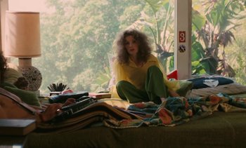 Movie still from “Lions Love (... and Lies)” (1969), directed by Agnès Varda – A woman sitting on top of a bed next to a window; Medium shot, High angle