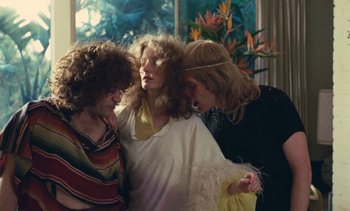 Movie still from “Lions Love (... and Lies)” (1969), directed by Agnès Varda – A group of people standing next to each other in front of a window; Medium shot, High angle