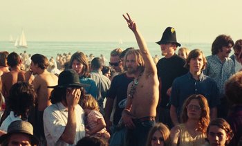 Movie still from “Lions Love (... and Lies)” (1969), directed by Agnès Varda – A crowd of people standing on a beach; Medium shot, High angle