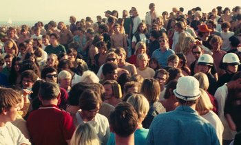 Movie still from “Lions Love (... and Lies)” (1969), directed by Agnès Varda – A large crowd of people gathered on the beach; Extreme Wide shot, High angle