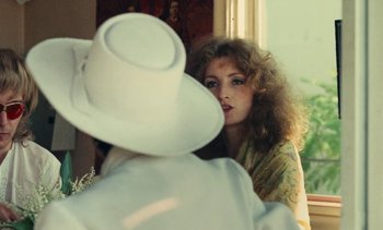 Movie still from “Lions Love (... and Lies)” (1969), directed by Agnès Varda – A woman looking at her reflection in a mirror; Close Up shot, Over the shoulder angle