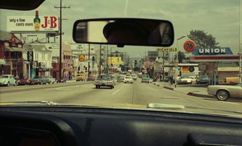 Movie still from “Lions Love (... and Lies)” (1969), directed by Agnès Varda – A view from inside a car looking out the windshield; Extreme Wide shot, High angle