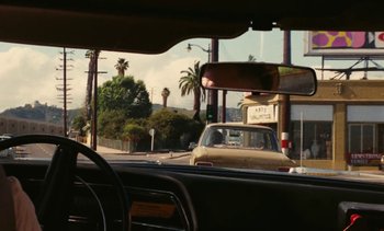 Movie still from “Lions Love (... and Lies)” (1969), directed by Agnès Varda – A view from inside a car looking out the windshield; Wide shot, Over the shoulder angle