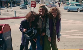 Movie still from “Lions Love (... and Lies)” (1969), directed by Agnès Varda – A group of people that are standing in the street; Medium shot, Low angle
