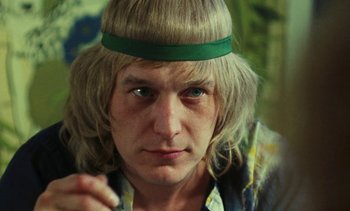 Movie still from “Lions Love (... and Lies)” (1969), directed by Agnès Varda – A person wearing a headband; Close Up shot, Low angle