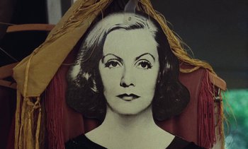 Movie still from “Lions Love (... and Lies)” (1969), directed by Agnès Varda – A picture of a woman's face hanging on the wall; Close Up shot, Overhead angle