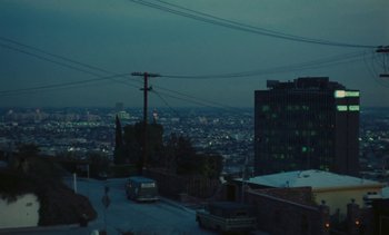 Movie still from “Lions Love (... and Lies)” (1969), directed by Agnès Varda – A view of a city at night from a hill; Extreme Wide shot, High angle
