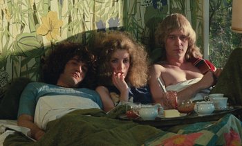 Movie still from “Lions Love (... and Lies)” (1969), directed by Agnès Varda – A group of people laying in a bed together; Medium shot, High angle