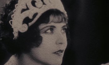 Movie still from “Lions Love (... and Lies)” (1969), directed by Agnès Varda – An old photo of a woman wearing a hat; Close Up shot, Low angle