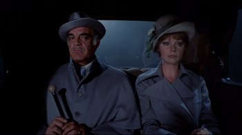 Movie still from “Lisa and the Devil” (1973), directed by Mario Bava – An older man and a woman in a car; Medium shot, High angle