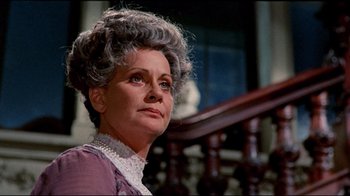 Movie still from “Lisa and the Devil” (1973), directed by Mario Bava – An older woman in a purple dress looking to her left; Close Up shot, Low angle