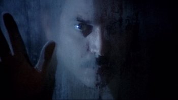 Movie still from “Lisa and the Devil” (1973), directed by Mario Bava – A person's face in a dark room; Extreme Close Up shot, High angle